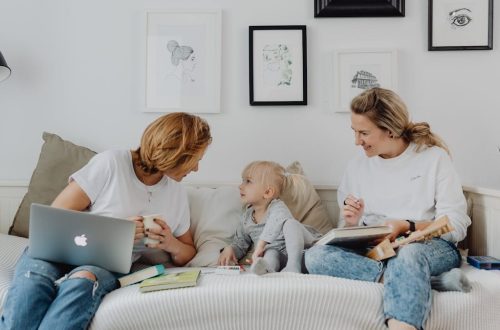 A mother and daughter enjoy a cozy bonding time at home, sharing laughs and love.