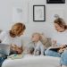 A mother and daughter enjoy a cozy bonding time at home, sharing laughs and love.