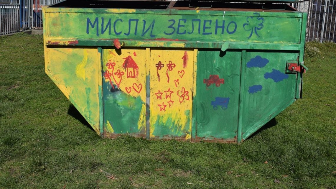 A colorful, green dumpster with the text "think green."