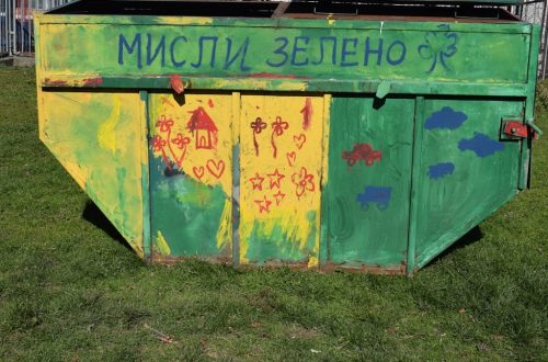 A colorful, green dumpster with the text "think green."