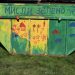 A colorful, green dumpster with the text "think green."